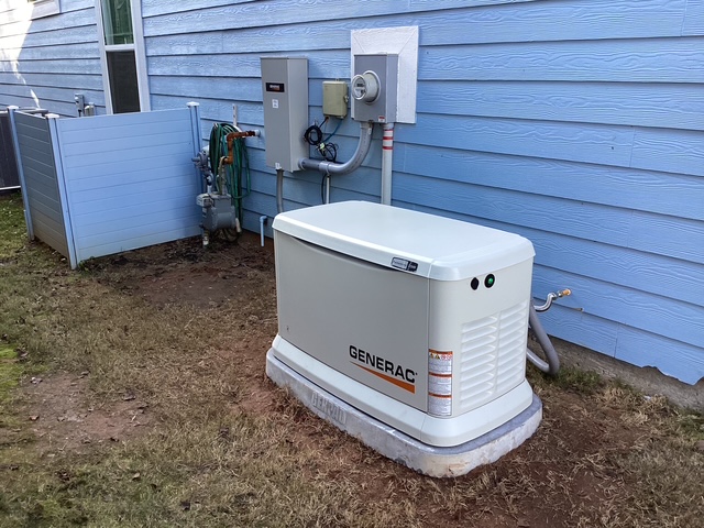 Generac generator installed with gas line and disconnect on a blue-sided Upstate SC home