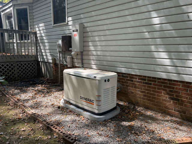Generac standby generator installed beside a vinyl-sided Upstate SC home